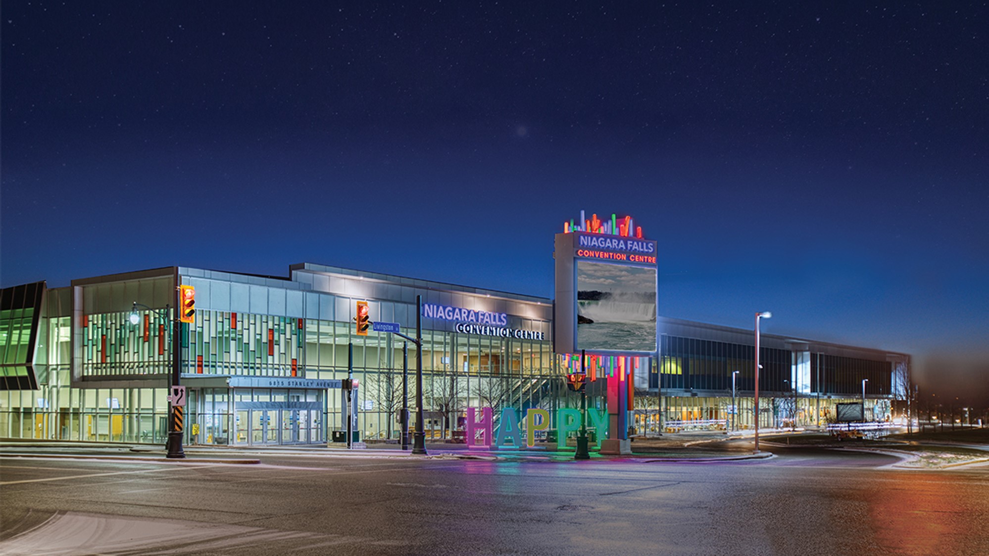Niagara Falls Convention Centre lit up at night with a prominent sign standing out against the dark sky.
